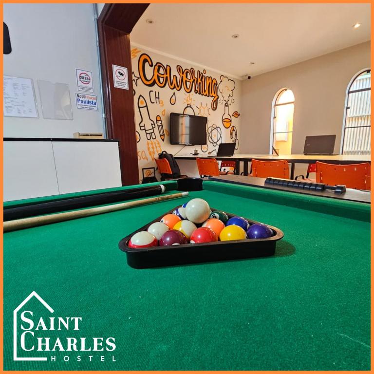 a billiard room with a pool table with balls at Saint Charles Hostel in São Carlos