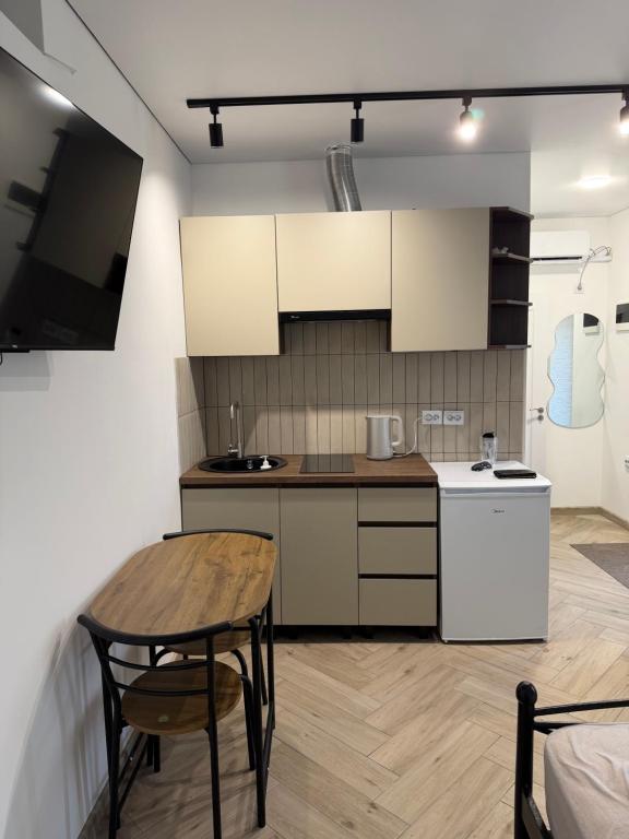 a kitchen with a wooden table and a table and a table and a table at Central House in Cahul