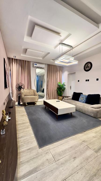 a living room with a couch and a coffee table at Leria Living luxury 2 bedroom wuye, Abuja in Ankuru