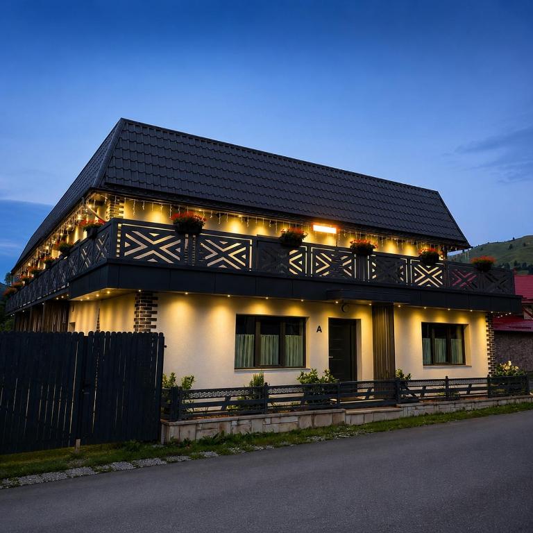 a house with a black roof with lights on it at Fram Apartments in Soci
