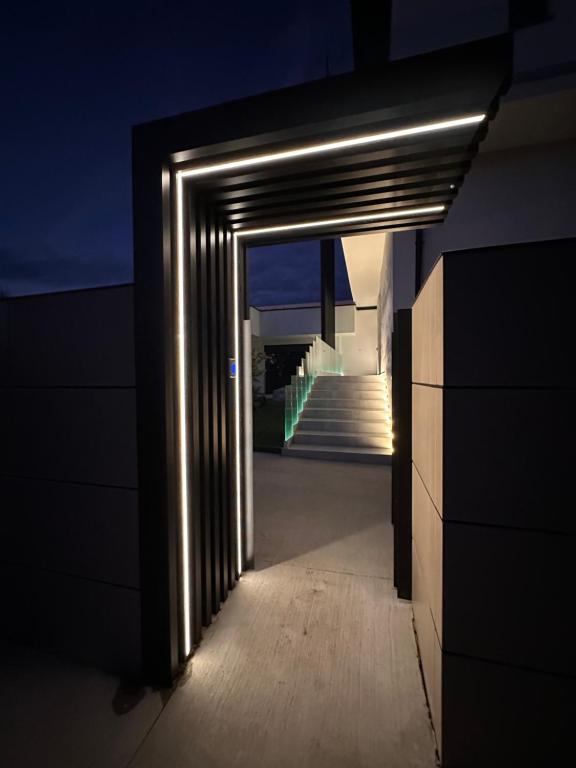 a hallway leading to a room with a staircase at Apartmán Maťko in Levice