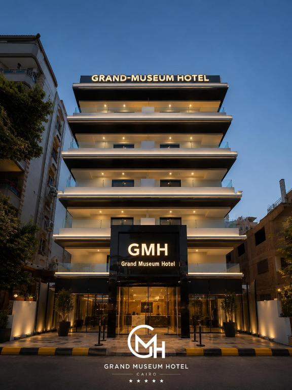a large building with a sign in front of it at Grand Museum Hotel Giza in Cairo