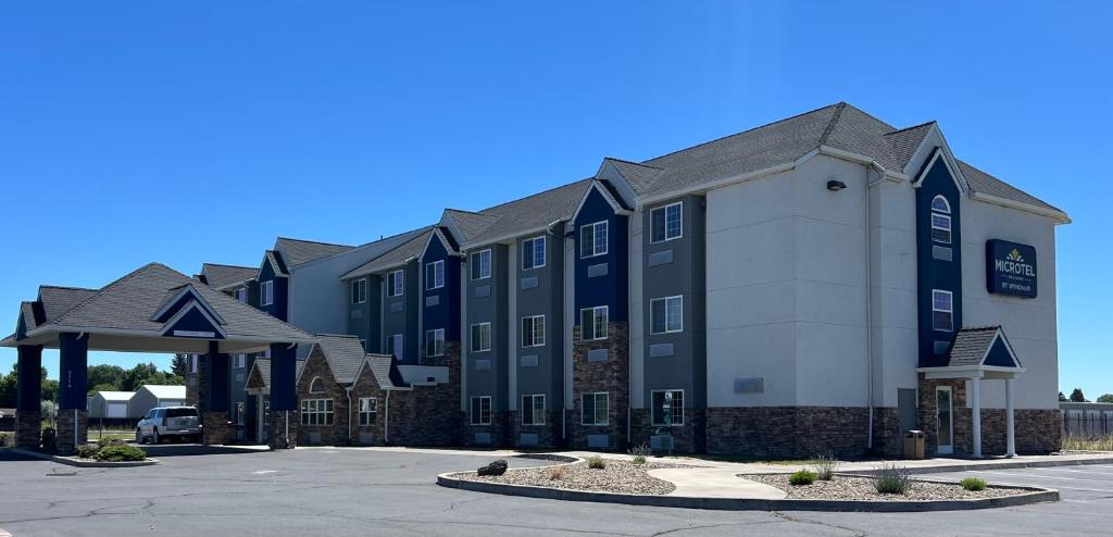 a large building with a parking lot in front of it at Microtel Inn & Suites by Wyndham Klamath Falls in Klamath Falls