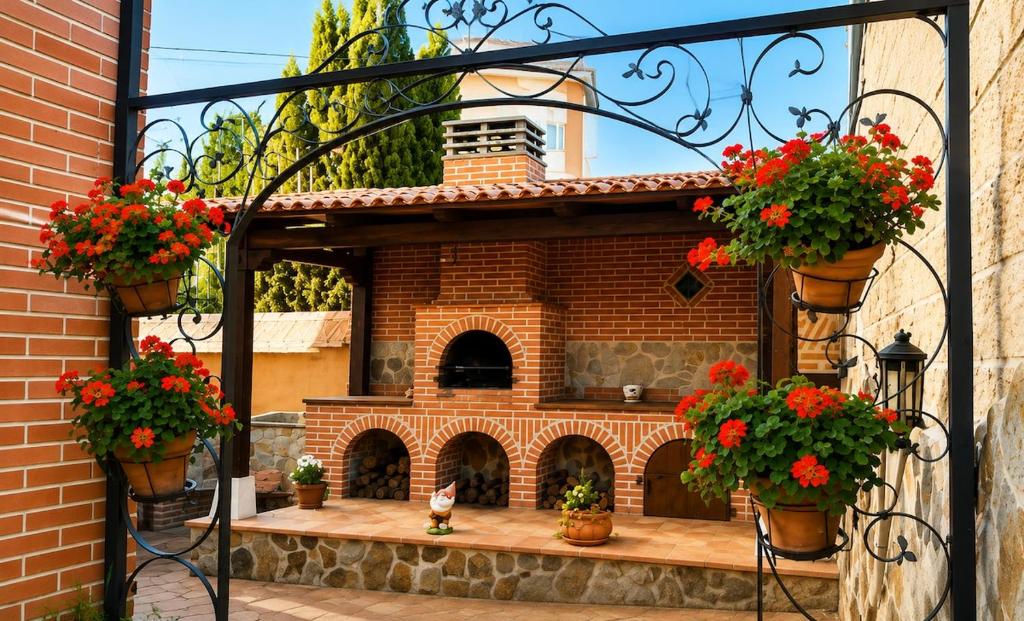 a model of a house with flowers in pots at Oasis Segovia in San Cristóbal de Segovia