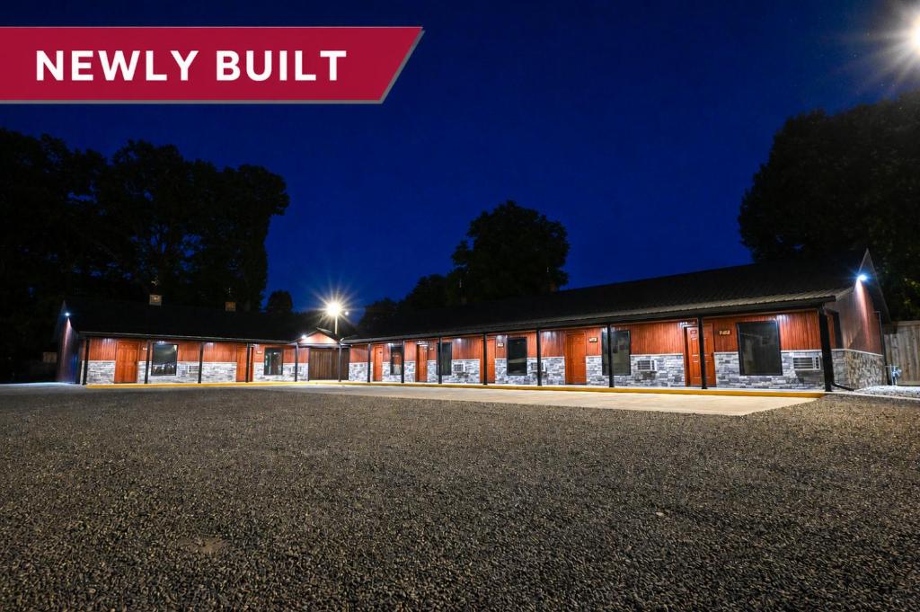 a newly built building at night with the words newly built at Benton Motel in Benton