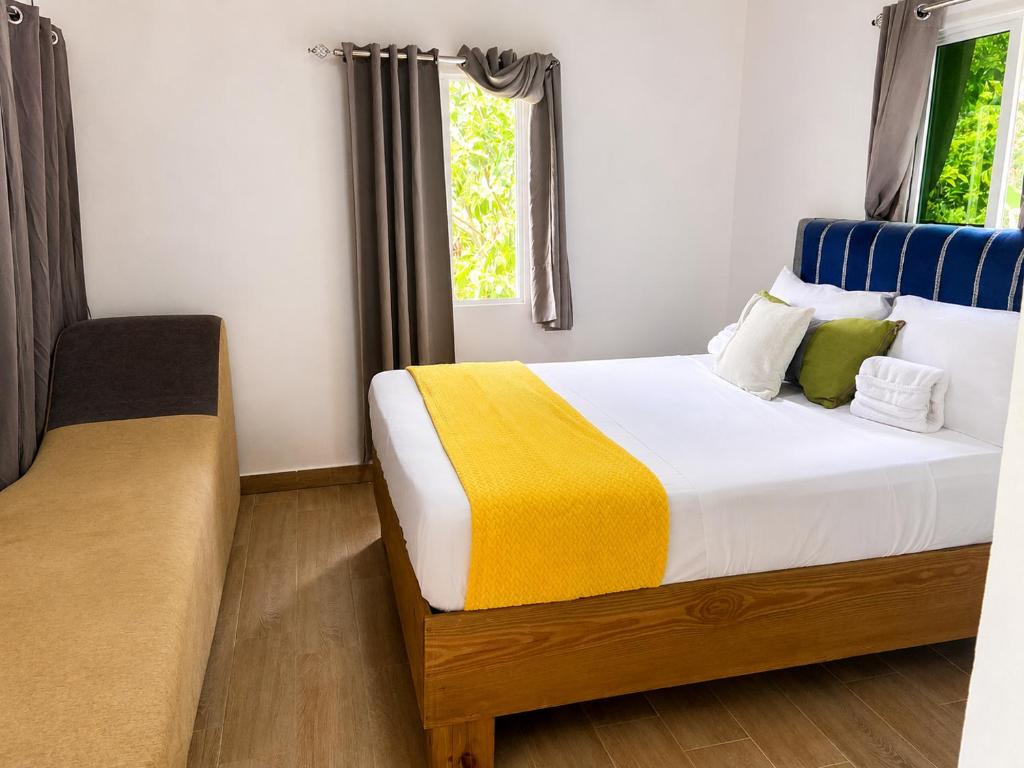 a bedroom with a large bed and a window at Villas Don Che, 2 villas in Jarabacoa