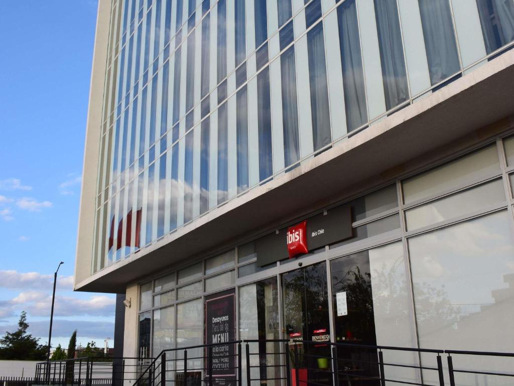 a tall building with a sign on the side of it at ibis Chia in Chía