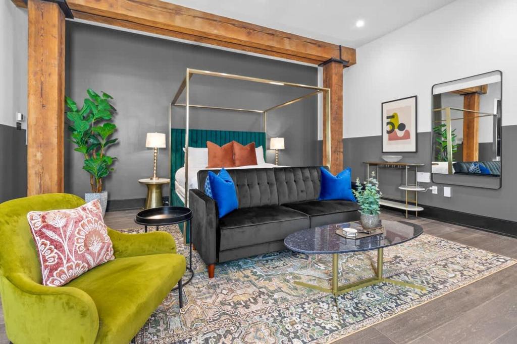 a living room with a couch and a table at King Bed Prime Location Downtown Hotel Suite in New Orleans