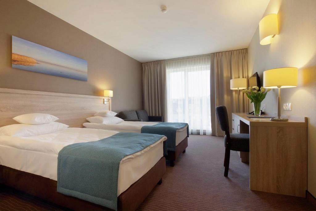 Postel nebo postele na pokoji v ubytování Tristan Hotel & SPA