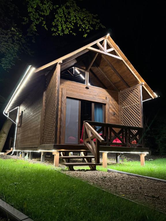 a small wooden house with a light on the front at Royal Ranch Nature Resort in Orhei