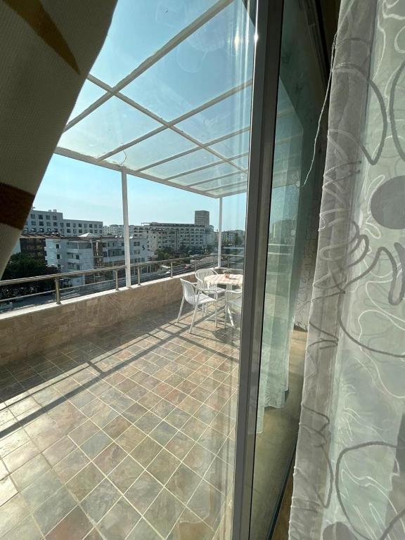 a balcony with a table and chairs on a roof at Apartment golem in Durrës