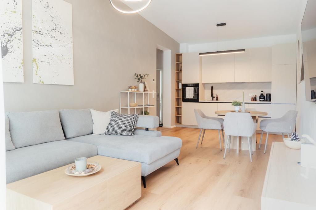 a living room with a couch and a table at MiHome - modern Living in Rottenmann