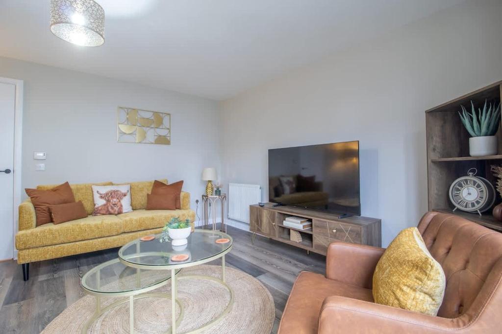 a living room with two couches and a tv at Lendrick House-Spacious 3 Bed House in Falkirk in Polmont