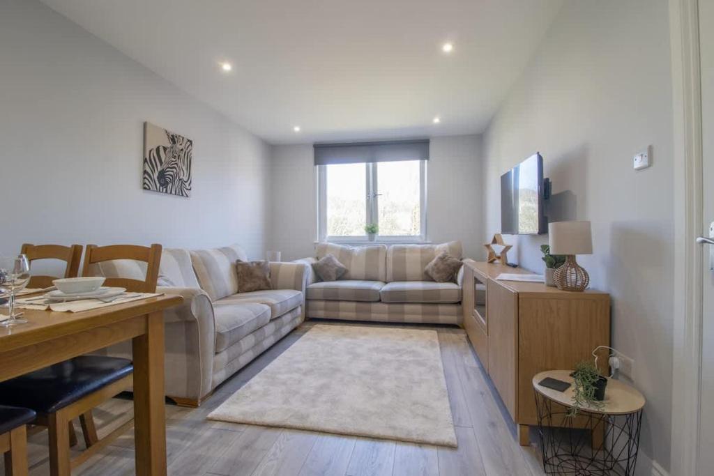 a living room with a couch and a table at Highfield Apartment- 2 Bed in Motherwell close to centre in Motherwell