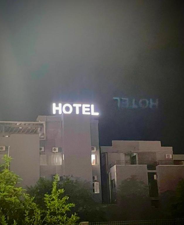 a hotel sign on top of a building at night at Hotel Guaíba in Guaíba