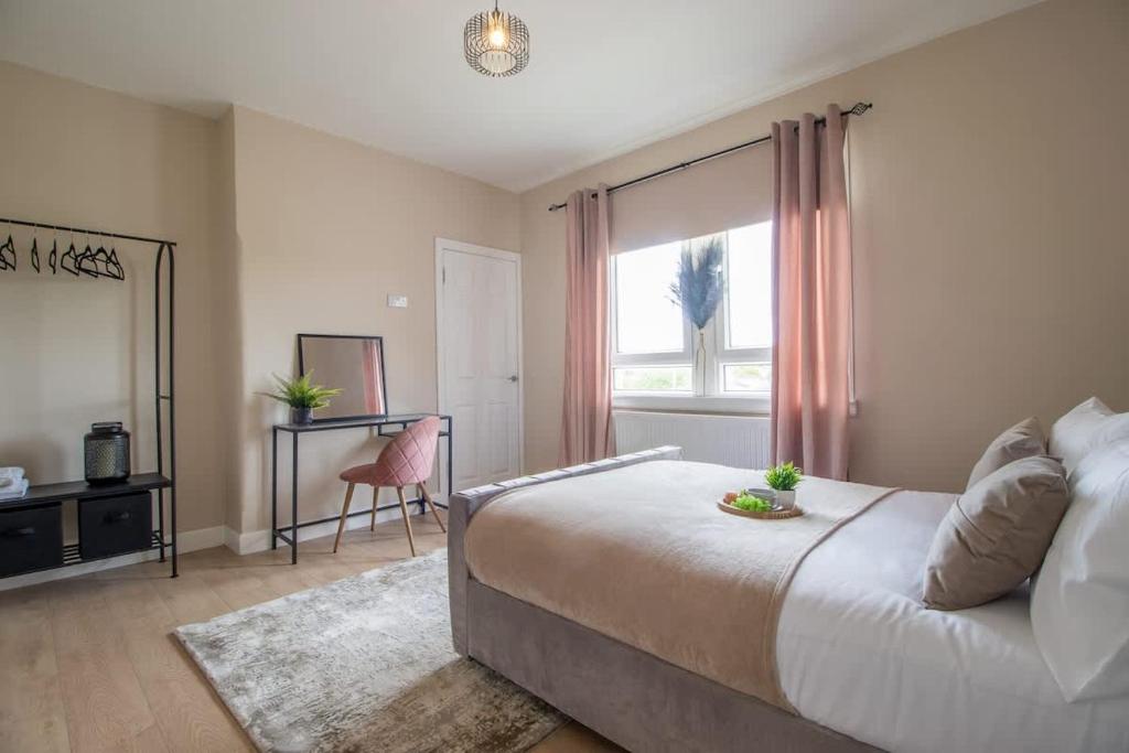a bedroom with a large bed and a window at Mitchell Apartment in Airdrie