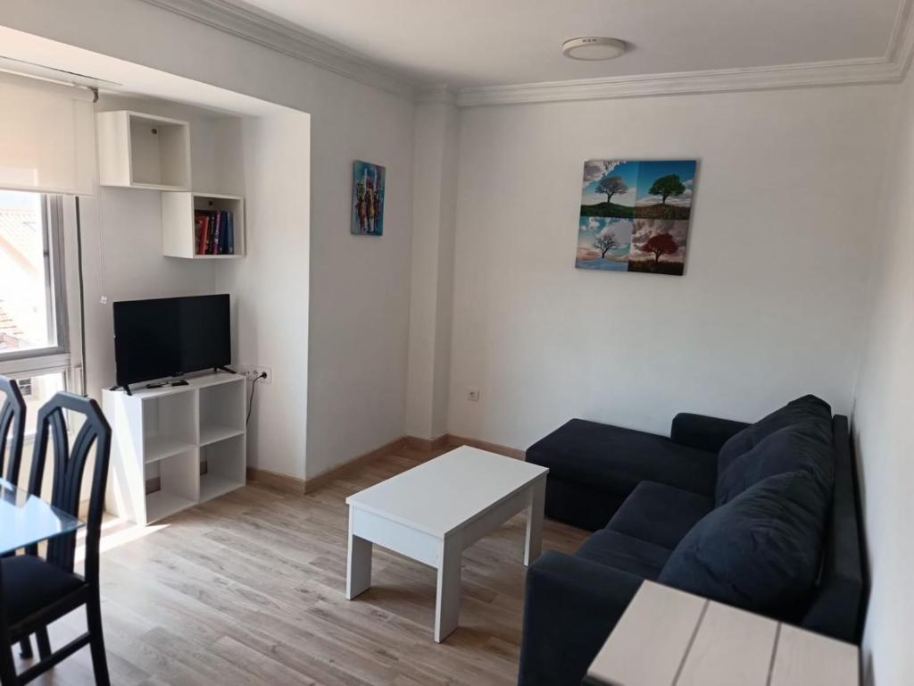 a living room with a couch and a table at Piso vacacional YaraMaya in Carballino