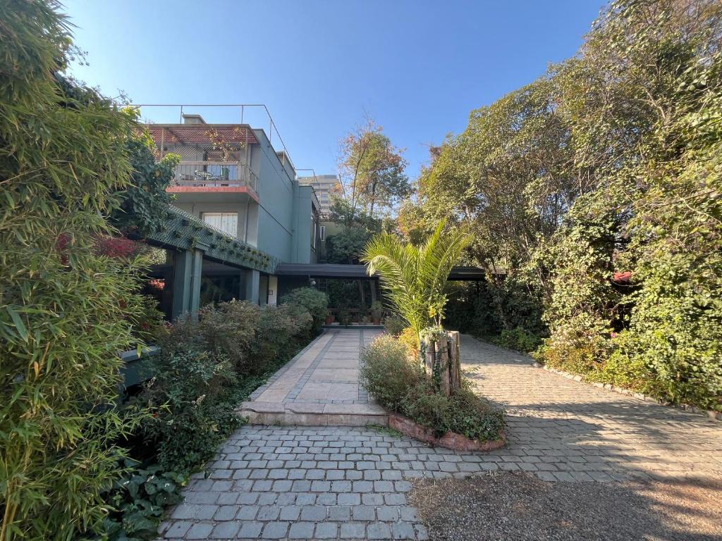 a walkway in front of a building with trees at Hotel Acacias de Vitacura in Santiago