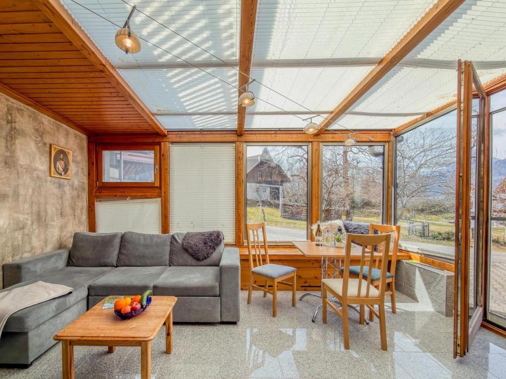 a living room with a couch and a table at Salburg Tröpolach in Tröpolach