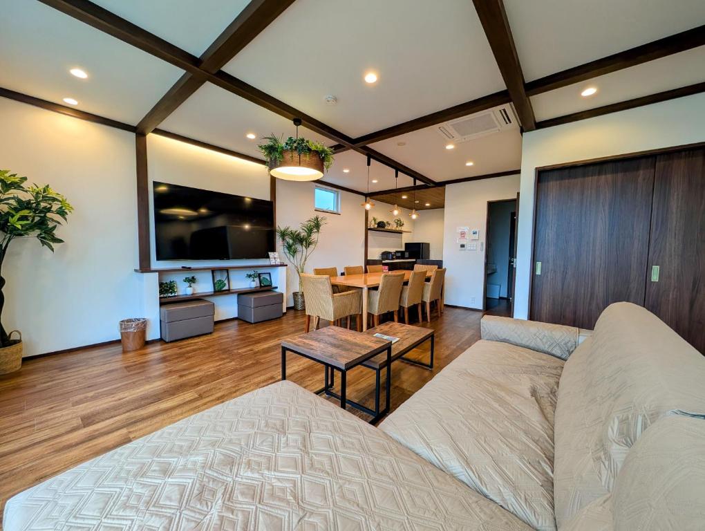 a living room with a couch and a table at Kawaguchiko Villa LaLuce in Fujikawaguchiko
