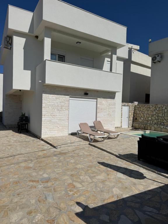 a house with two chairs and a pool table at AD Homes in Ravanj