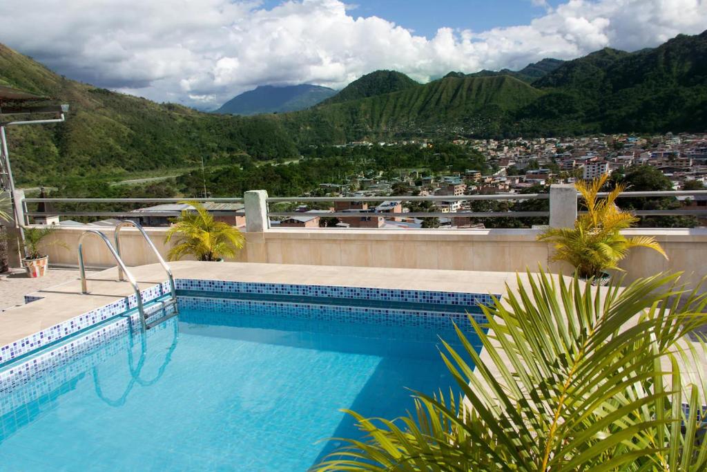 a swimming pool with a view of a city at Hotel Prince Selva Central in La Merced