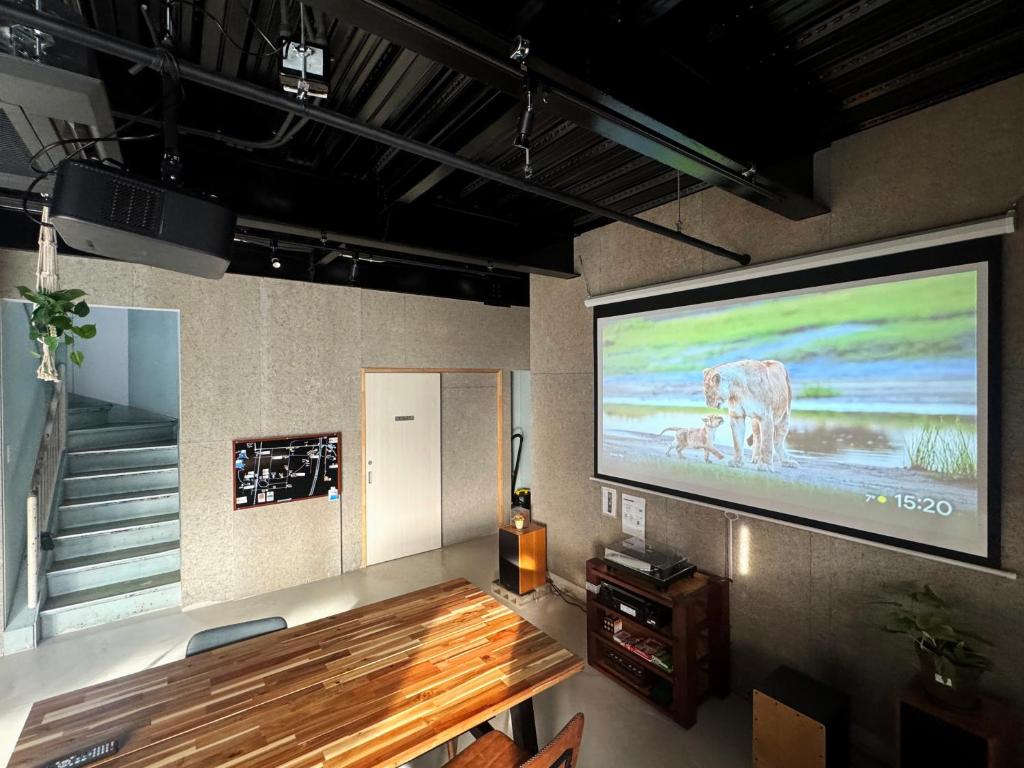 a large projection screen on a wall in a room at 富士Base御殿場 Station-Side in Gotemba