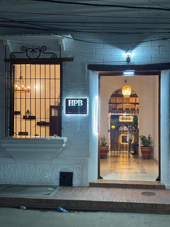 a front door of a store at night at HOTEL PLAZA BOLIVAR MOMPOX ubicado en el centro histórico con parqueadero interno in Mompos