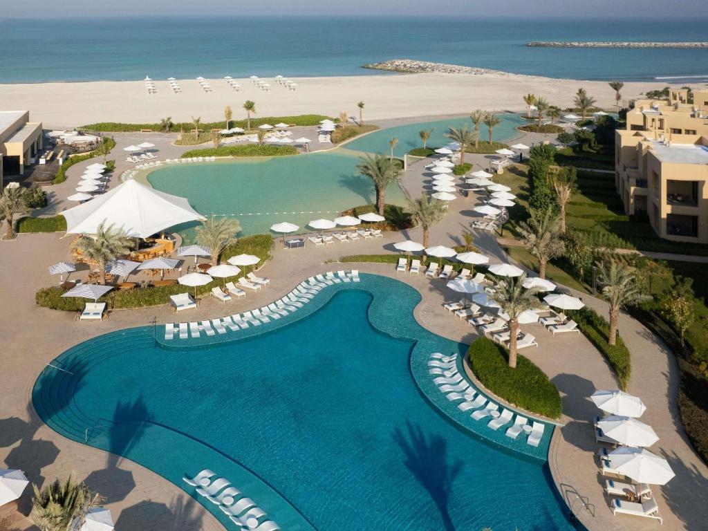 an aerial view of a resort with a pool and beach at Sofitel Ras Al Khaimah Al Hamra Beach Resort in Ras al Khaimah