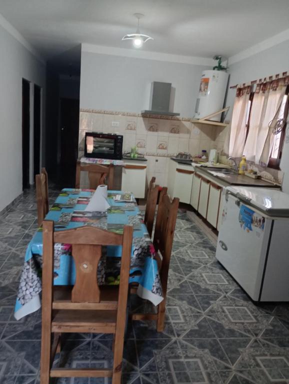 a kitchen with a table with chairs and a refrigerator at Alojamientos Rinconcito don Antonio casa in Tinogasta