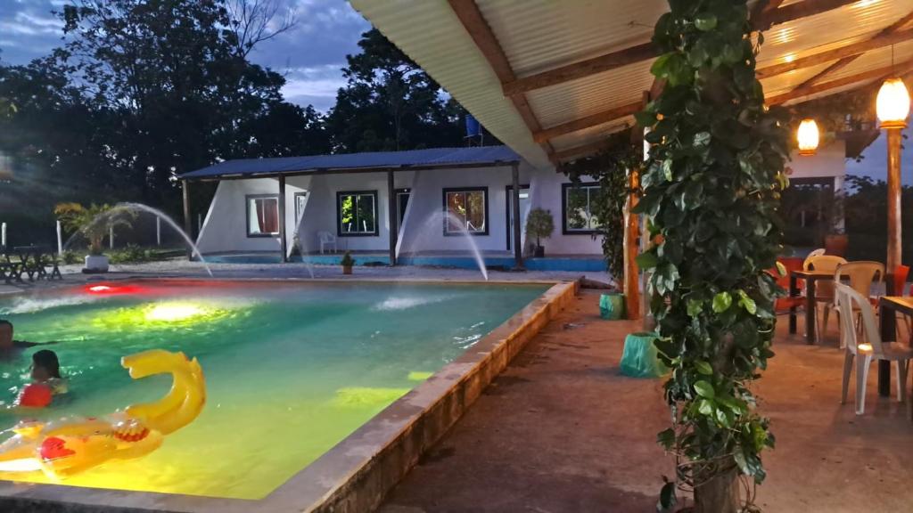 a swimming pool in the backyard of a house at Finca campestre Wakanda in Doradal