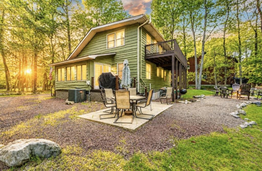 a green house with a table and chairs at Lake harmony estates beach and lake access in Lake Harmony