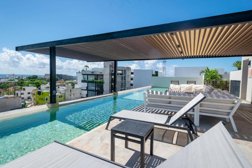 a swimming pool on the roof of a building at 2Br Condo W Rooftop Pool & Backyard in Playa del Carmen