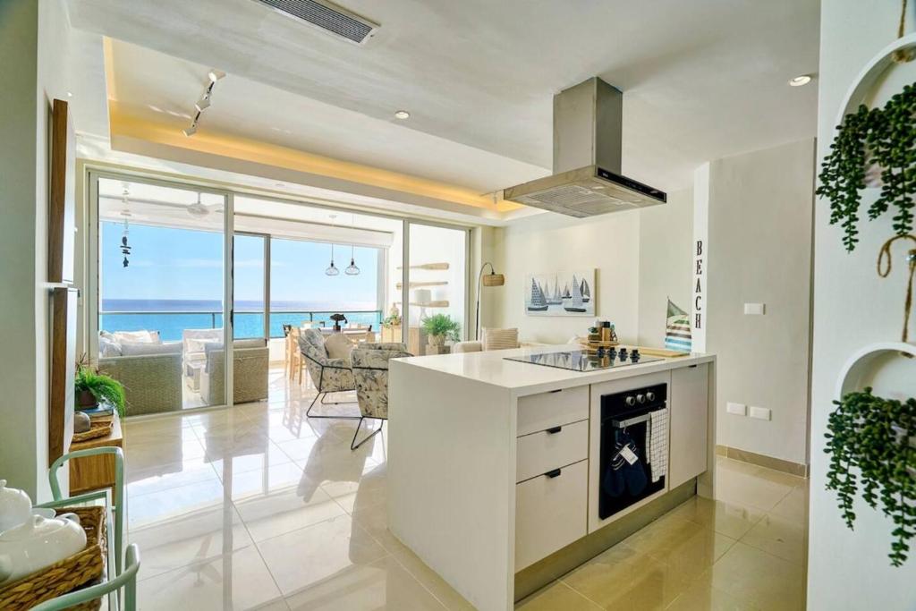 a kitchen with a view of the ocean at Marbellaluxessence Beachfrontpool11Thfloor in Villas del Mar