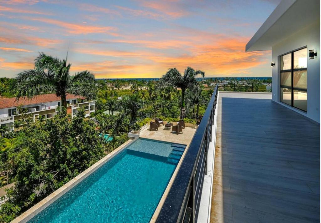 an image of a swimming pool on the balcony of a house at Beach & Mountain Villaterrenaspoolbbq6Br in Las Terrenas
