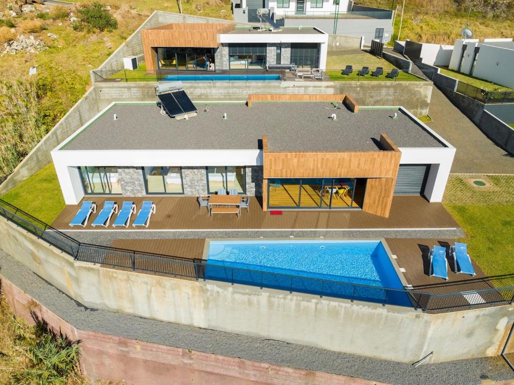 an aerial view of a house with a swimming pool at Casa Mozart Ii Sea View, Pool & Sunny Retreat in Estreito da Calheta