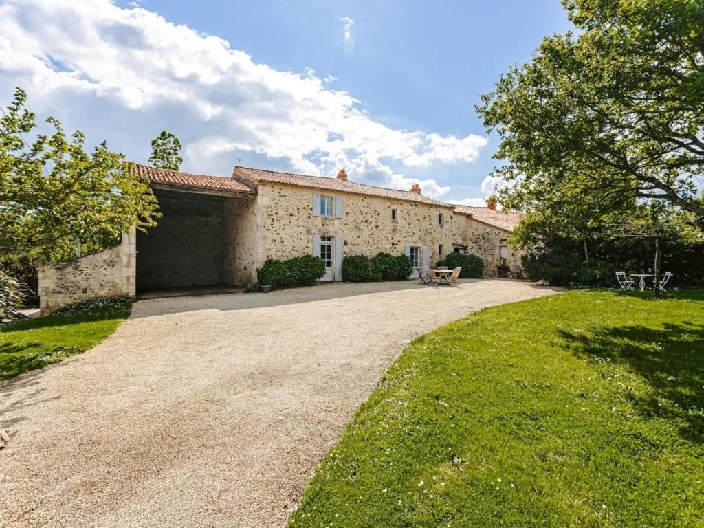 an exterior view of a house with a driveway at Holiday Home Saint-Laurent Pool Retreat in La Chapelle-Thémer