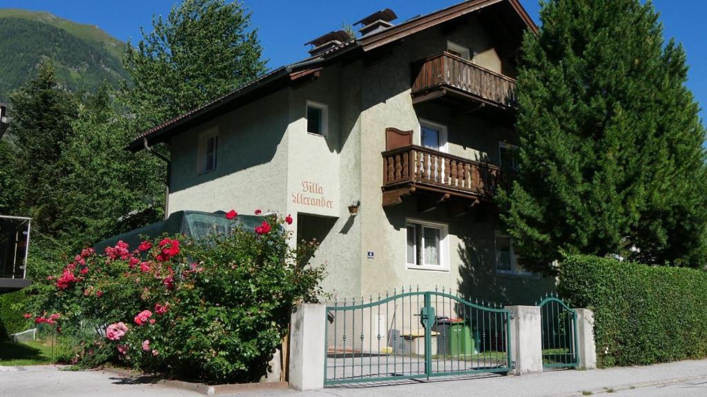 a building with a balcony and a fence at Villa Alexander in Bad Hofgastein