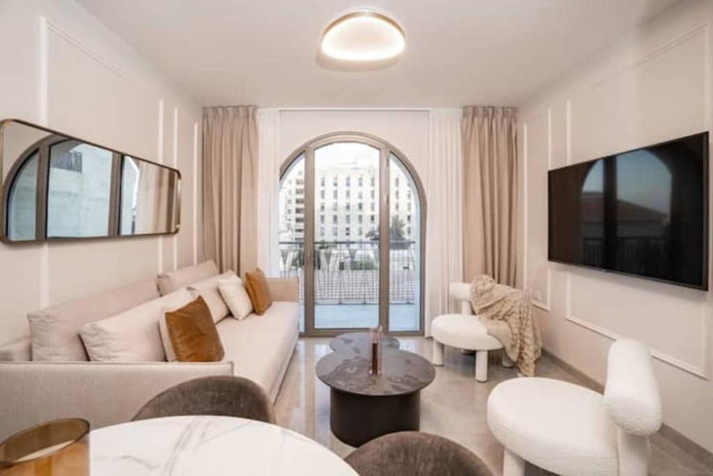 a living room with a couch and a table at 1 Br Apartment In Shaul Adler in Jerusalem