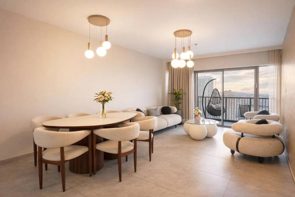 a living room with a table and chairs and a couch at 2 Br Apartment In Savyoney Tower W Room in Jerusalem