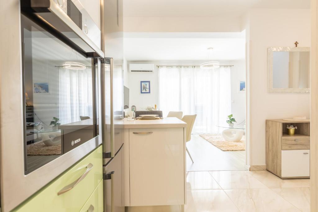 a kitchen with a refrigerator and a counter top at Gea Maris Apartment in Kaštela