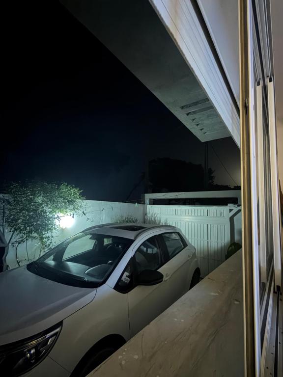 a car parked next to a garage at night at Maison dar allouche in Kelibia