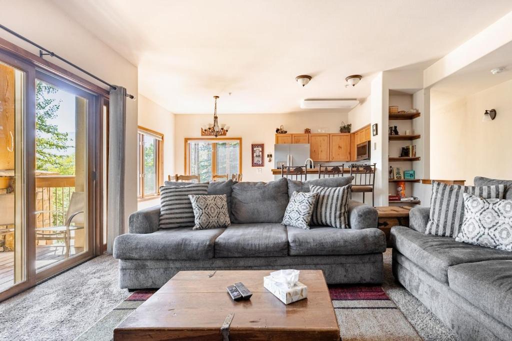 a living room with a couch and a table at Breckenridge Luxury Condo, Easy Access to Ski Lifts! in Breckenridge