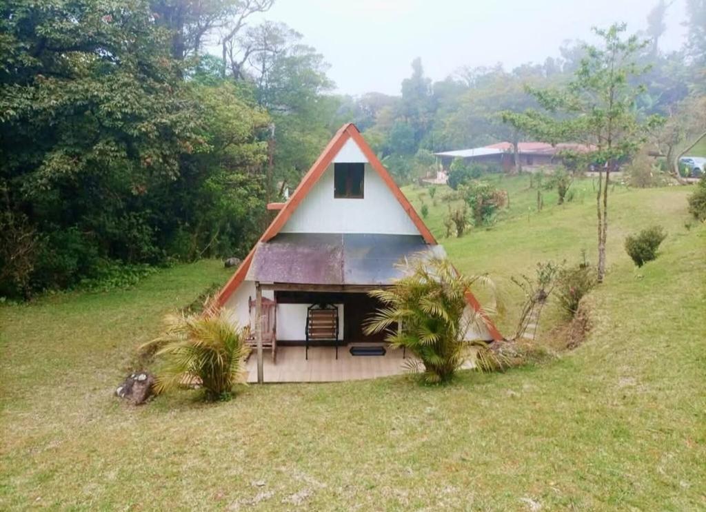 a small house with a red and white roof at private and pleasant in Zapotal