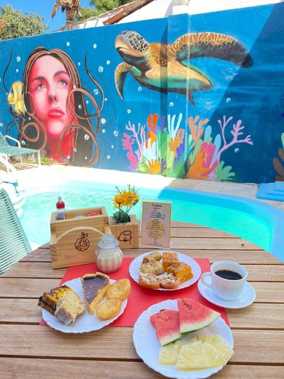 a table with two plates of food on a table with a table at Pousada Zayon Jeri in Jericoacoara