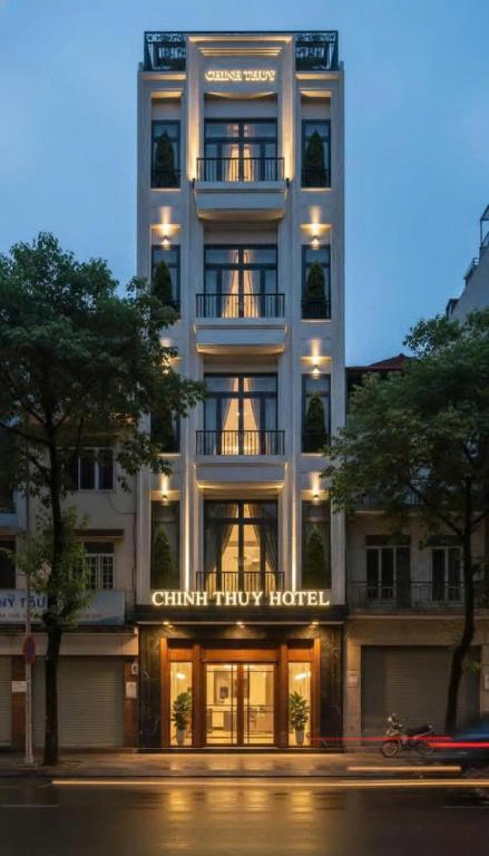 a tall white building with a sign on it at Khách sạn Chinh Thuỷ in Sầm Sơn