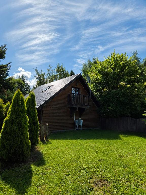 a small house with a balcony and a yard at The DACHA escape in Viimsi