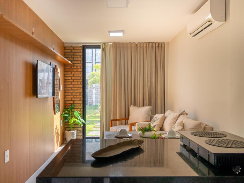 a living room with a couch and a table at Villa 18 Atins Rooftop com piscina in Barreirinhas