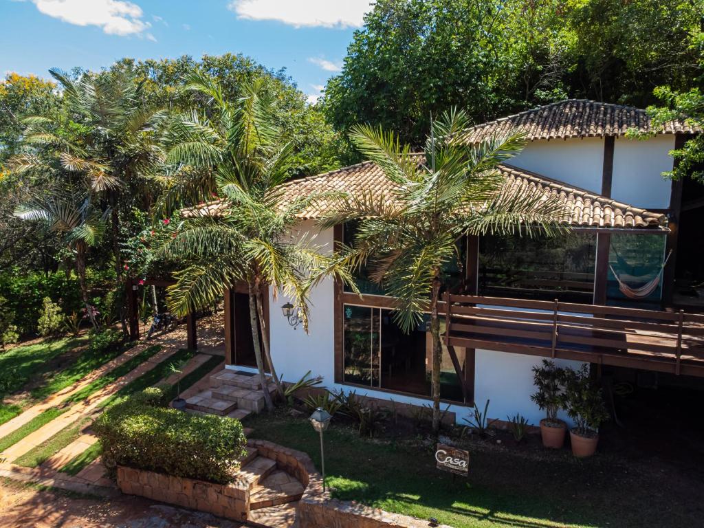 a house with palm trees in front of it at Pousada Vila de Charme in Lençóis