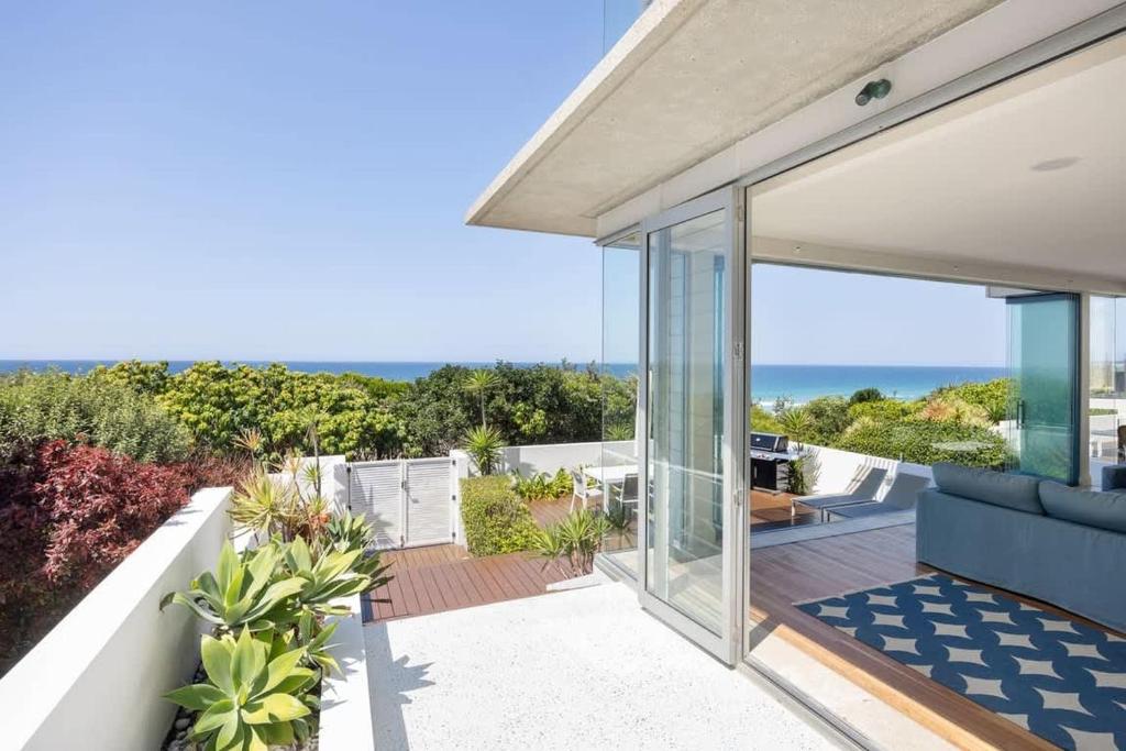 a house with a view of the ocean at The Beach Shack: Getaway on Sunshine Beach in Noosa Heads